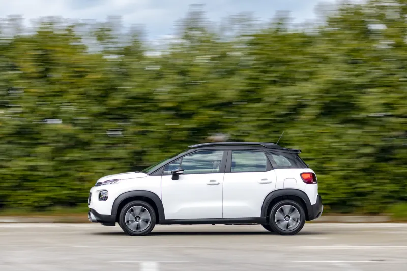 zagreb, croatia - march 6, 2020  man is driving citroen c3 aircross fast on a road aircross is heightened, more robust, suv-like version of a citroen small c3 model