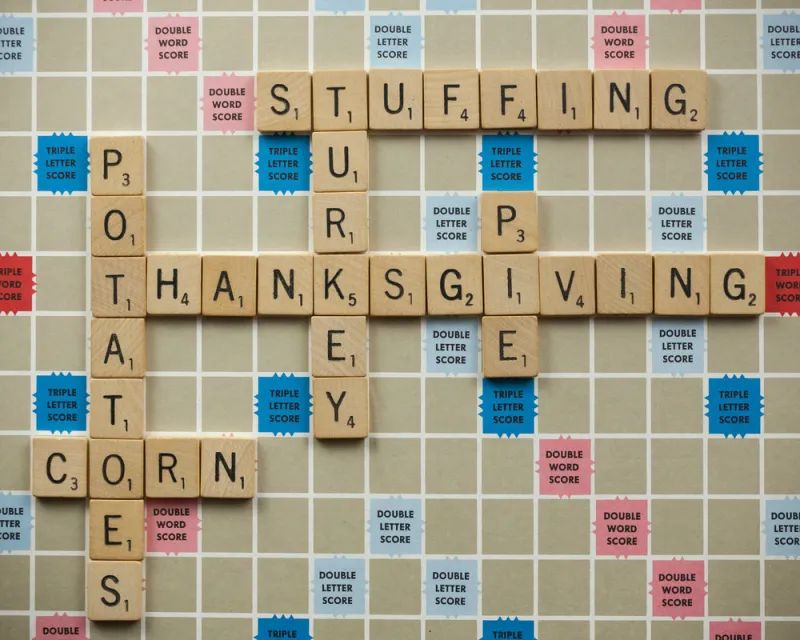 woodbridge, new jersey - november 9, 2018  scrabble tiles spell out various thanksgiving foods on a vintage board