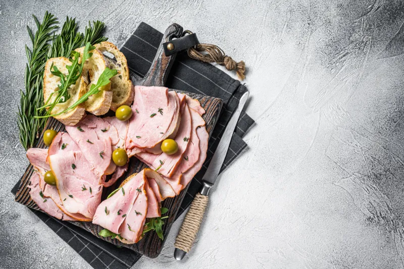 toast with pork ham and olives white background top view copy space