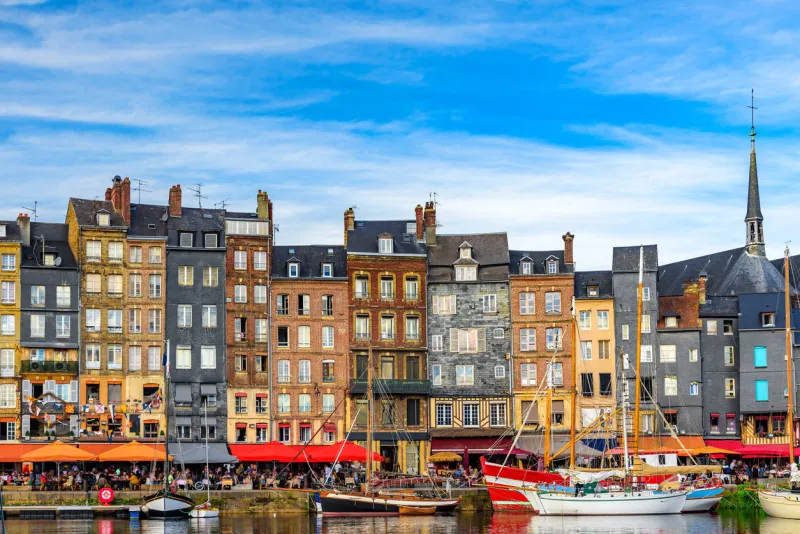 the harbor of honfleur, normandy, france with yachts in sunny day