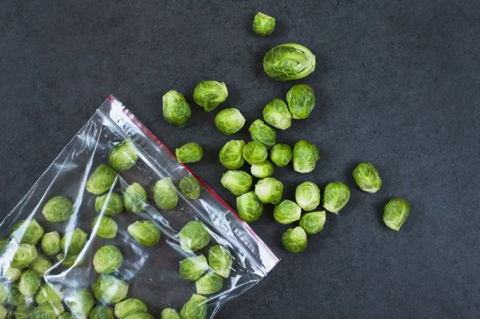 brussels sprouts in a opened plastic bag, top view