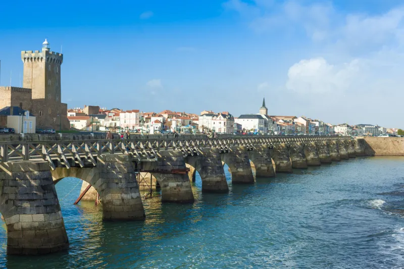 les sables d'olonne, france - december 25, 2012  sightseers on archway bridge on the canal of la chaume on december 25, 2012 the historical city attracts tourists all year long