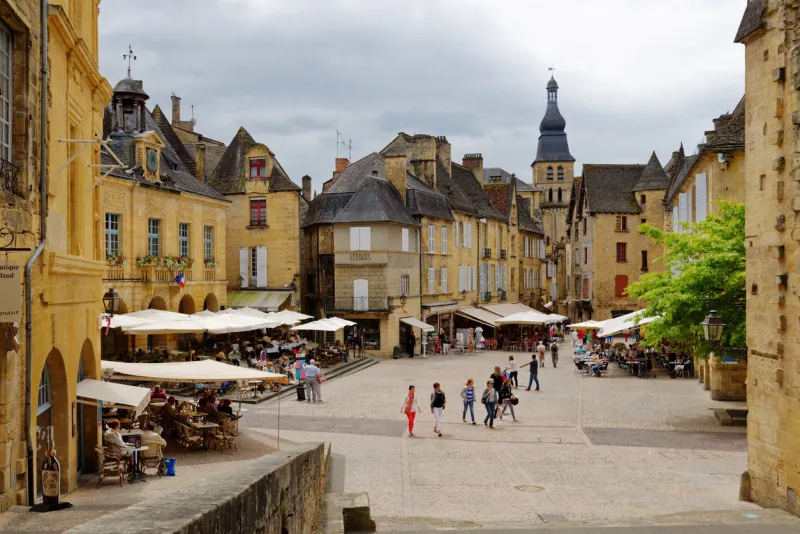 sarlat, france - june 28, 2013  tourist walking in the historic center of old city since 2002, the old city of sarlat included in unesco tentative list