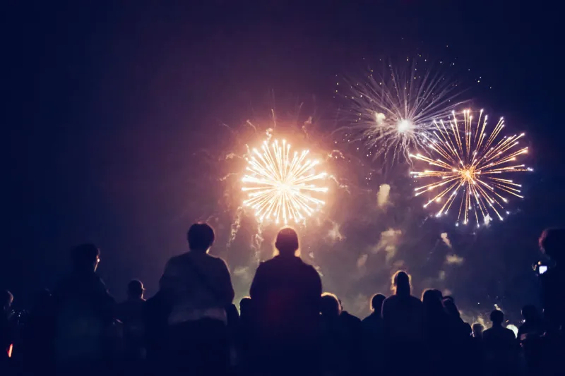 crowd watching fireworks and celebrating new year eve