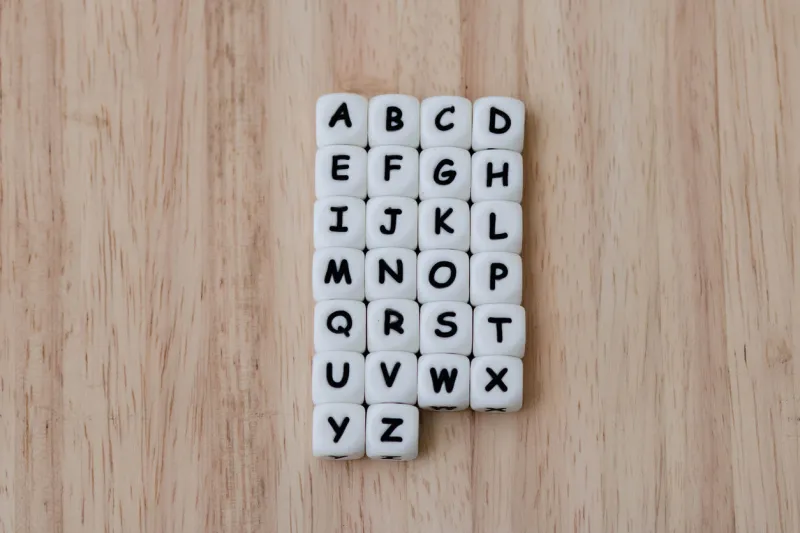 text dice cube concept   letter dices alphabet on wooden background block of alphabet studded on the floor