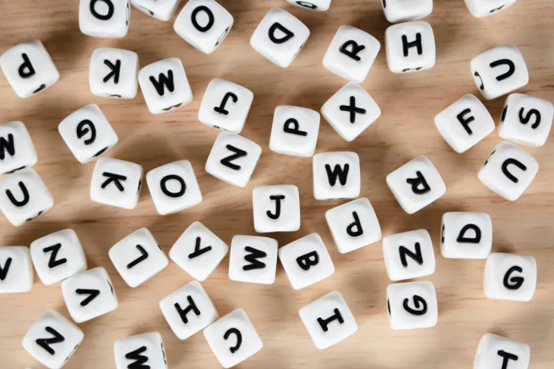 text dice cube concept   letter dices alphabet on wooden background block of alphabet studded on the floor