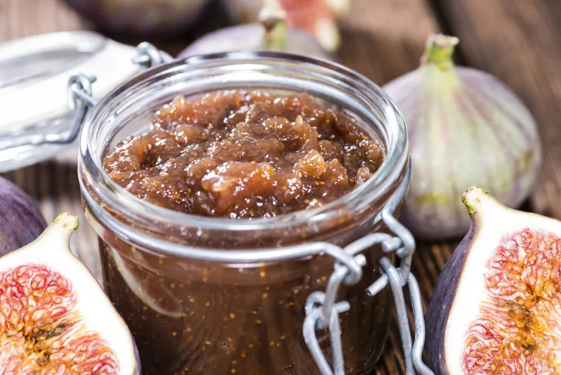 portion of fresh homemade fig jam on wooden background
