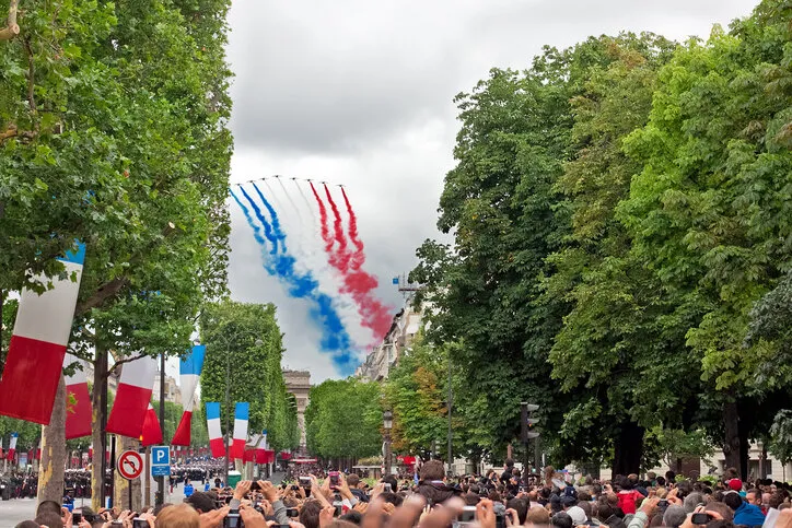 paris, france - july 14, 2012  people are watching french patrouille de france at a military parade in the republic day (bastille day) on champs elysees