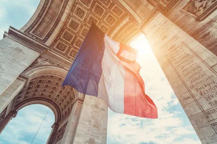 french flag at arc de triomphe during bastille day
