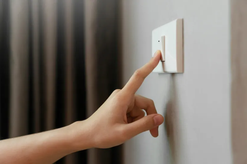 close up of female finger is turn off on lighting switch at home power, energy, saving electrical, copy space