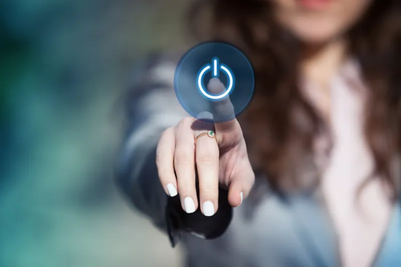 businesswoman pressing power button on touch screen hand tapping start button on digital projection screen