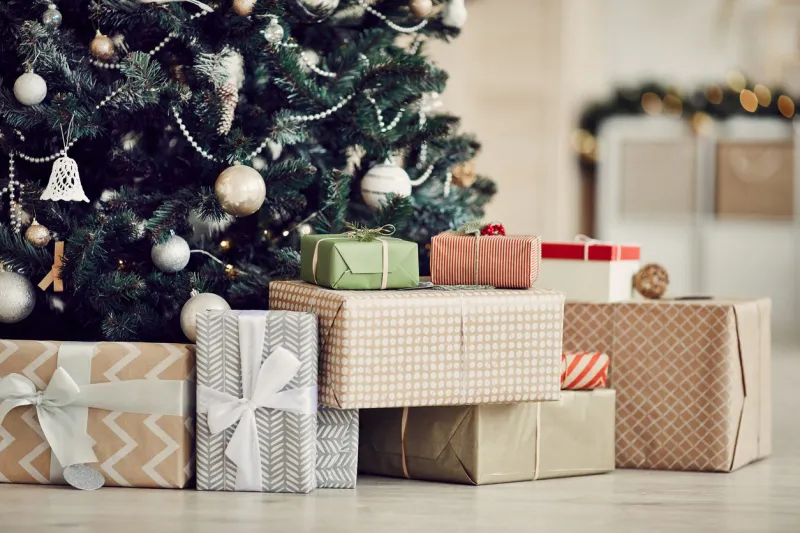 close-up of christmas presents in wrapping paper are on the floor under the christmas tree