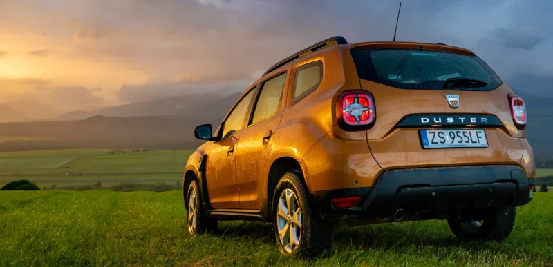 poprad,slovakia-july 2020 dacia duster suv in the mountain wilderness during the evening downpour