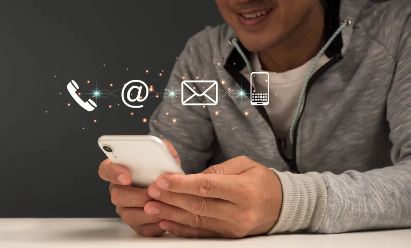 contact us or call our customer service hotline businessman using a laptop and interacting with virtual screen contact icons ( email, address, live chat, internet )