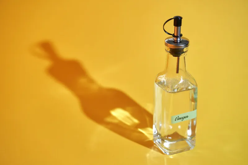 white vinegar on ellow background