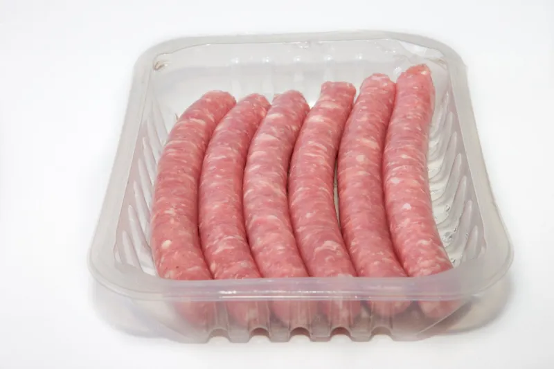 spicy pork sausages on the package, isolated on white background