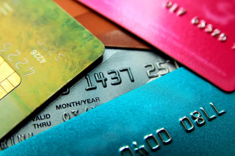 stack of multicolored credit cards close-up view with selective focus