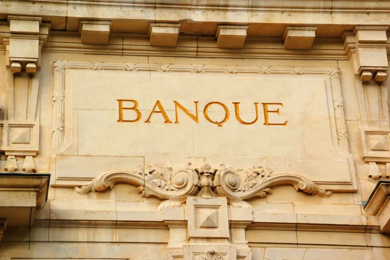 inscription on the pediment of a stone building indicating a bank