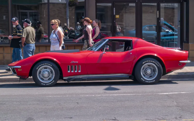 halifax, nova scotia, canada - july 19, 2009   1969 chevrolet corvette stingray at cars on quinpool road car show, halifax, nova scotia, canada people walk on the sidewalk near the vintage car