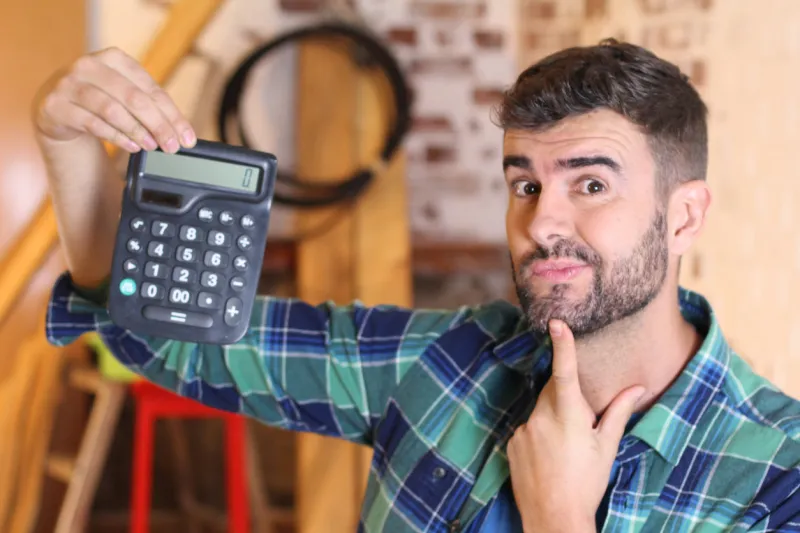 man using calculator during home renovations