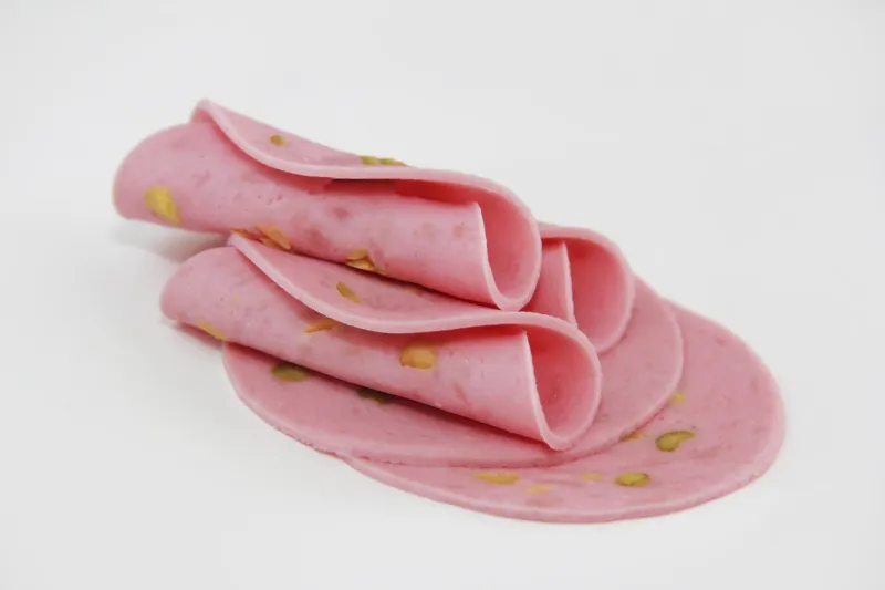 round thin pieces of meat sausage with a olive slices