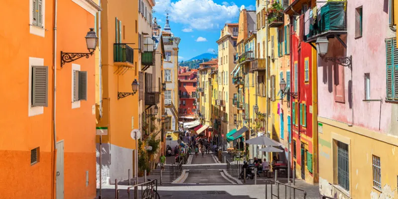 nice  narrow street in old tourist part of nice - fifth most populous city and one of the most visited cities in france, receiving 4 million tourists every year