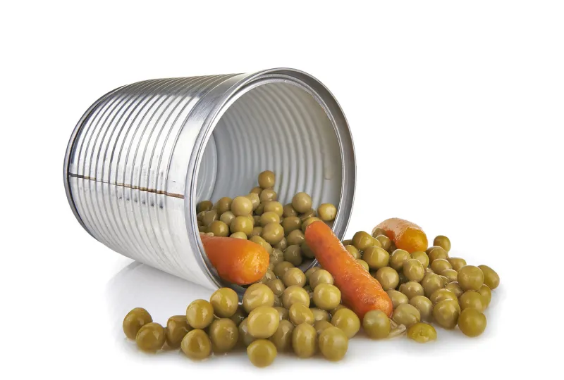 a tin of peas and carrots on white background