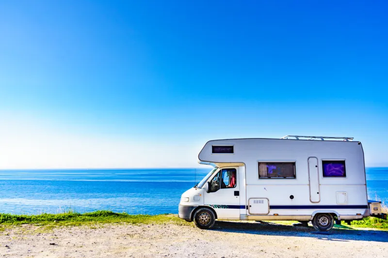 camper rv caravan on mediterranean coast in spain wild camping on sea shore holidays and travel in motor home