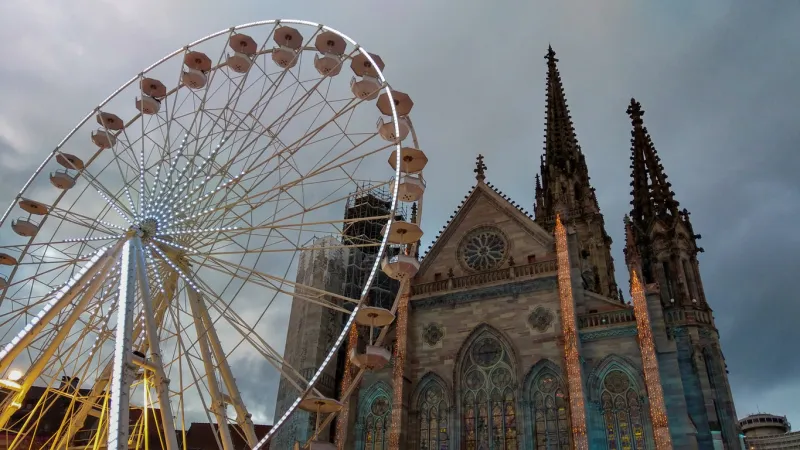 detail of the ferris wheel in the central square of themulhouse city during the christmas holidays, france