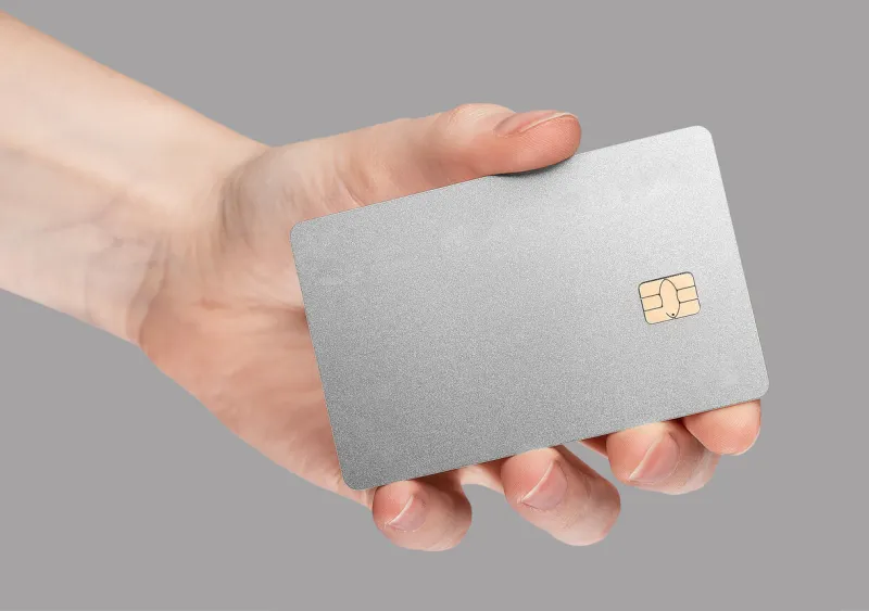gray stylish minimalistic bank credit card mockup in hand on gray background blank clean silver gray debit plastic bankcard with chip high quality photo
