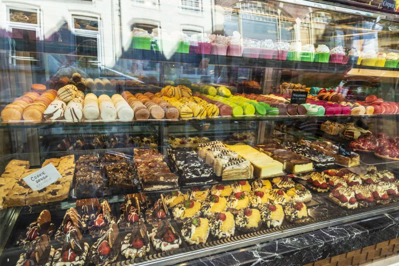 display of a candy store with a great assortment of cakes and macaroons in amsterdam, netherlands