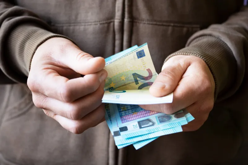 white male count euro bills in her hands