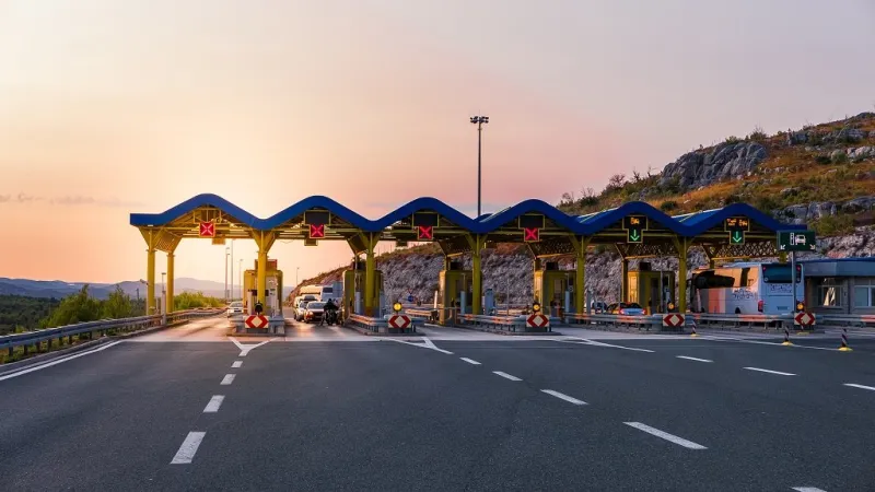 cars passing through the toll gate on the motorway, vivid trabel background