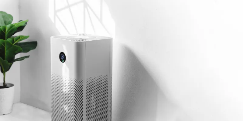 air purifier a living room, air cleaner removing fine dust in house protect pm 25 dust and air pollution concept