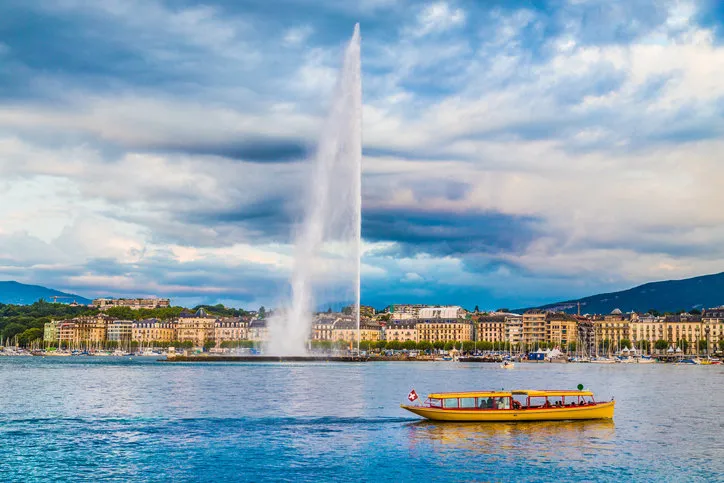 beautiful view of geneva skyline with famous jet d'eau fountain at harbor district in beautiful evening light, switzerland