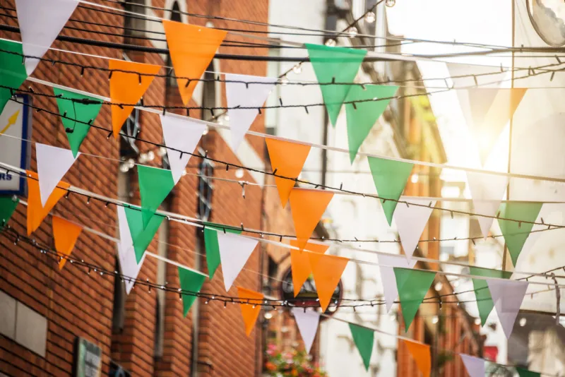 garland with irish flag colors in a street of dublin, ireland - saint patrick day celebration concept