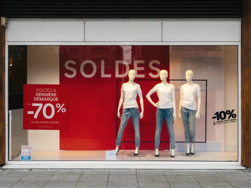 paris, france - jul 27, 2017  soldes inscription with mannequins wearing elegant clothes and special last minutes 70 percent discount sales for fashion products on central avenue