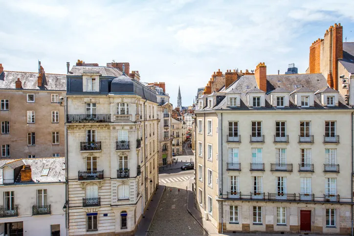 street view on the beautiful residential buildings andchurch tower in nantes city during the sunny day in france