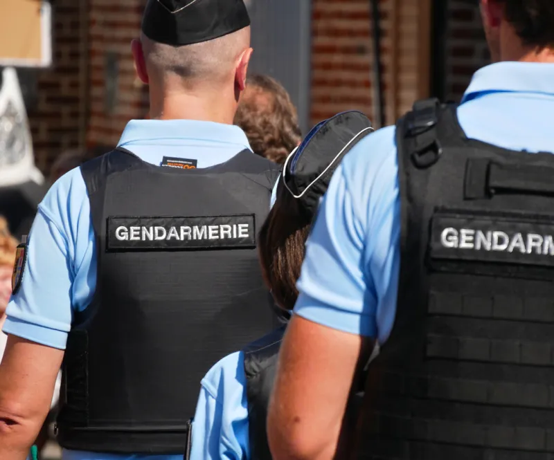 arleux, france - 09 02 2023   gendarmes seen from behind wearing bullet-proof vests and gendarmerie bibs