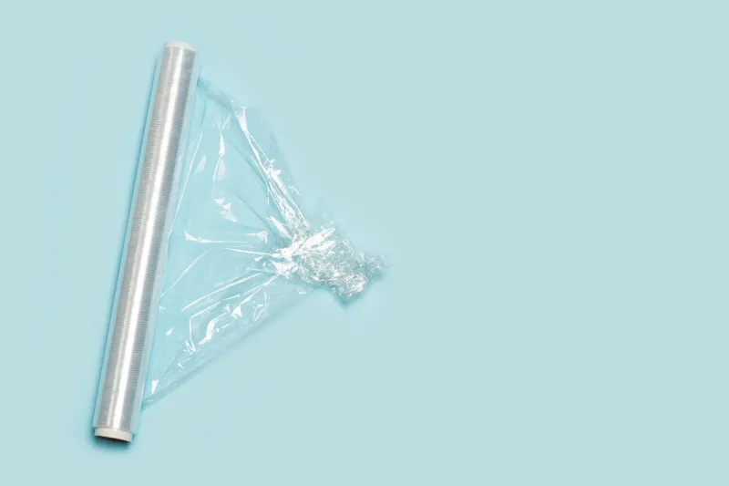 a roll of wrapping plastic stretch film on a light blue background