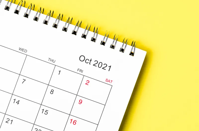 close up october 2021 calendar desk for organizer to plan and reminder on yellow background