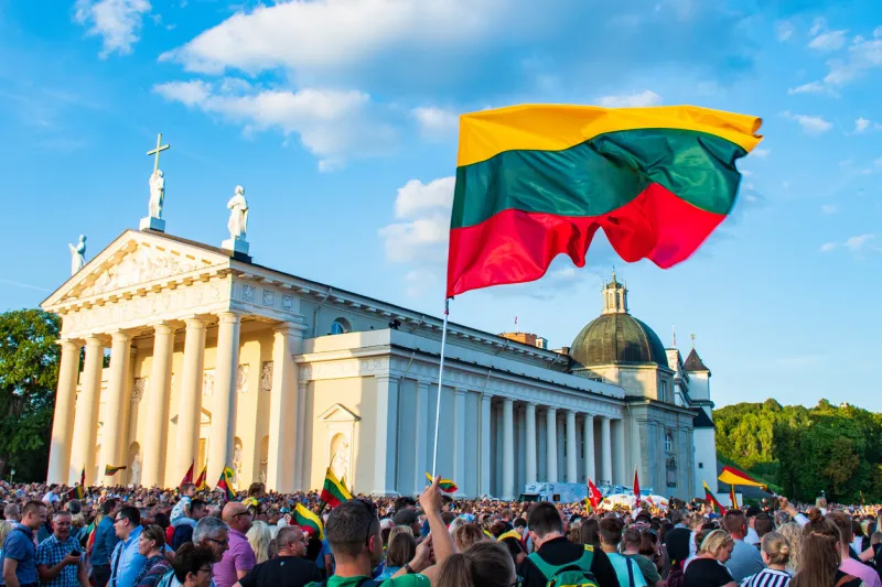 vilnius   lithuania - august 23 2019  lithuanian flag in the cathedral square in a celebration day of freedom and independence, with lithuanians people celebrating together