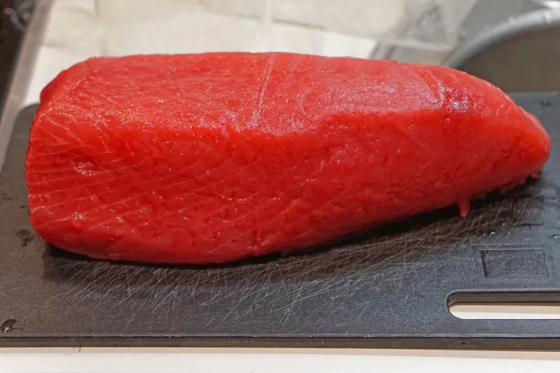 whole yellowfin tuna loin at cutting board