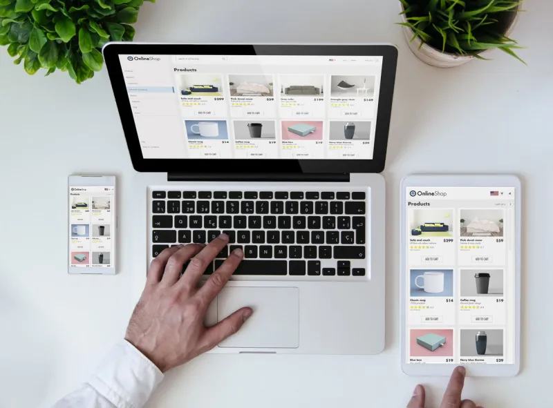 office tabletop with tablet, smartphone and laptop showing online shop responsive design website