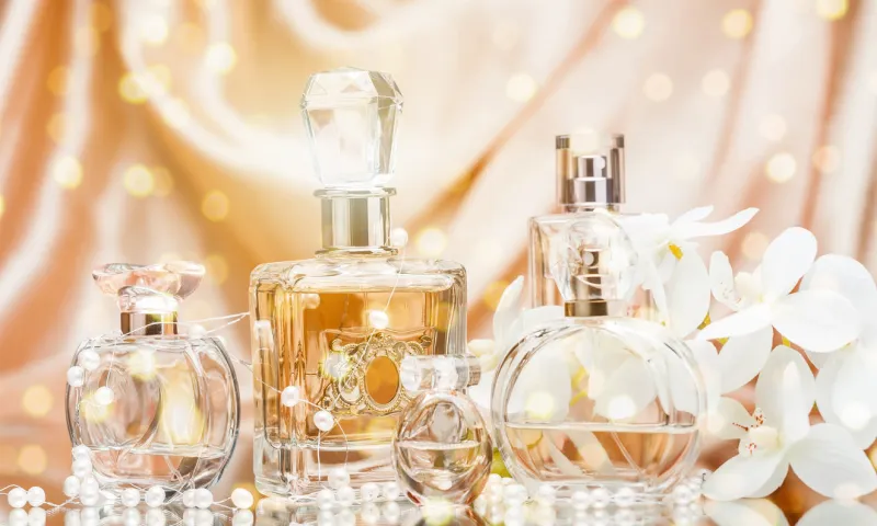 glass perfume bottles with flowers and pearls