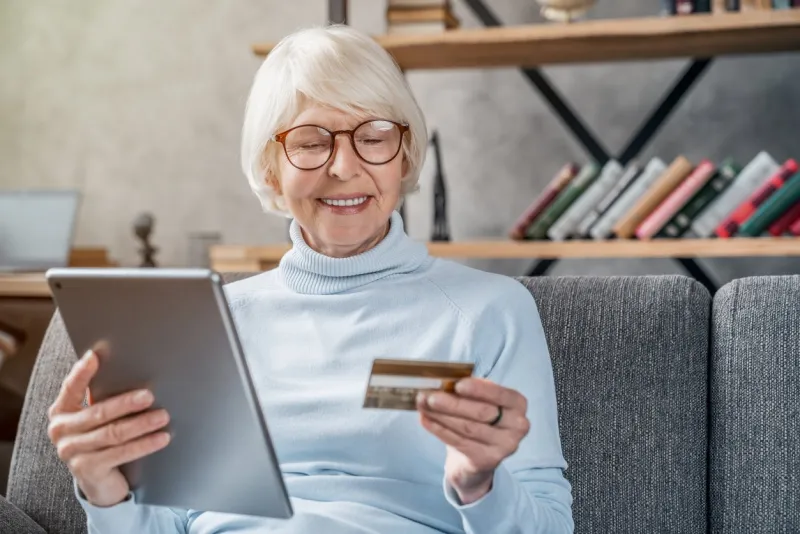 shopping online senior woman using tablet computer and credit card