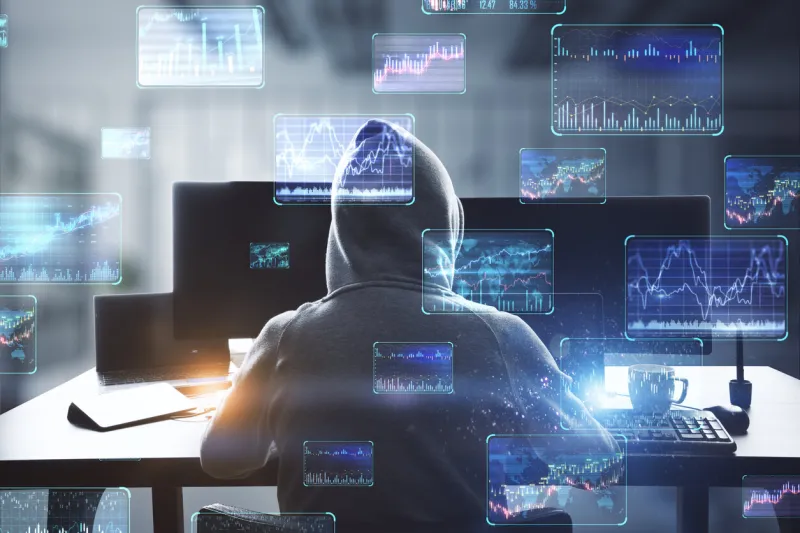 back view of hacker at desktop using computers with various forex screens on blurry office interior background cryptocurrency, hacking, bticoin trading and finance concept double exposure