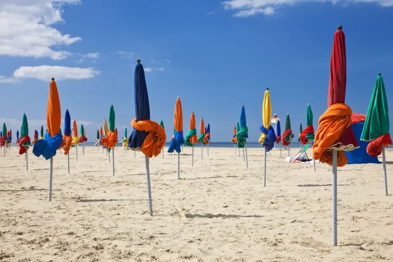 the famous colorful parasols on deauville beach, normandy, northern france, europe