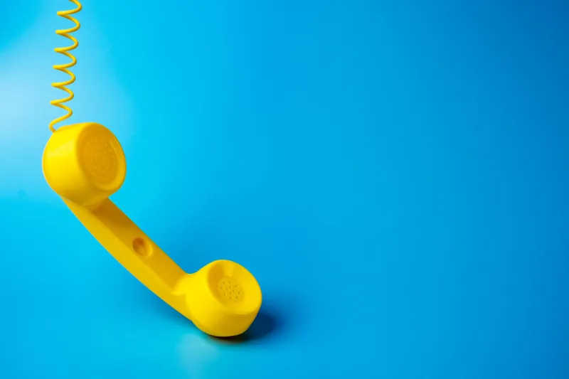 yellow telephone retro receiver on a blue background communication and technology