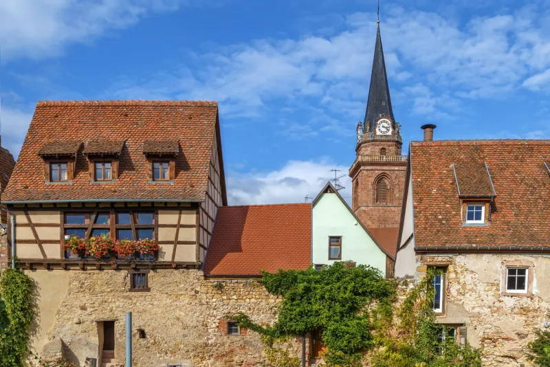street with historical houses and church in bergheim, alsace, france